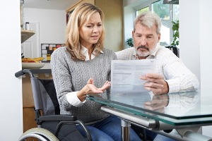 A woman looking at SSD paperwork, getting help form a Social Security Attorney in East Peoria IL