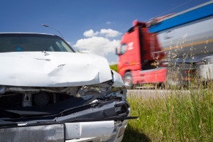 A damaged car on the side of the road, where the owner needs to call a Truck Accidents Lawyer in Pekin IL