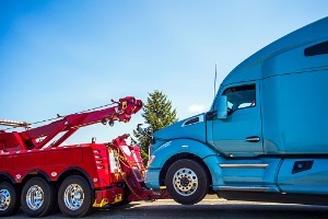A tow truck towing a semi, where a Truck Accident Attorney in Peoria IL is needed