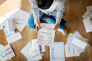 Person sitting in pile of paperwork Chapter 7 Bankruptcy Pekin IL
